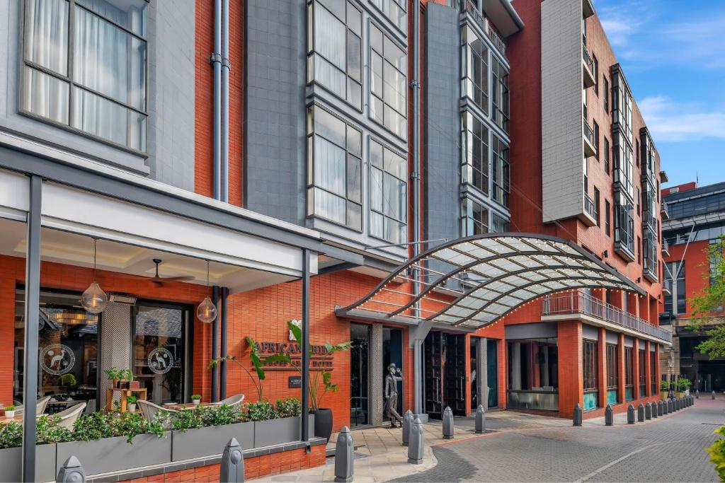 a group of buildings on a city street at African Pride Melrose Arch, Autograph Collection in Johannesburg