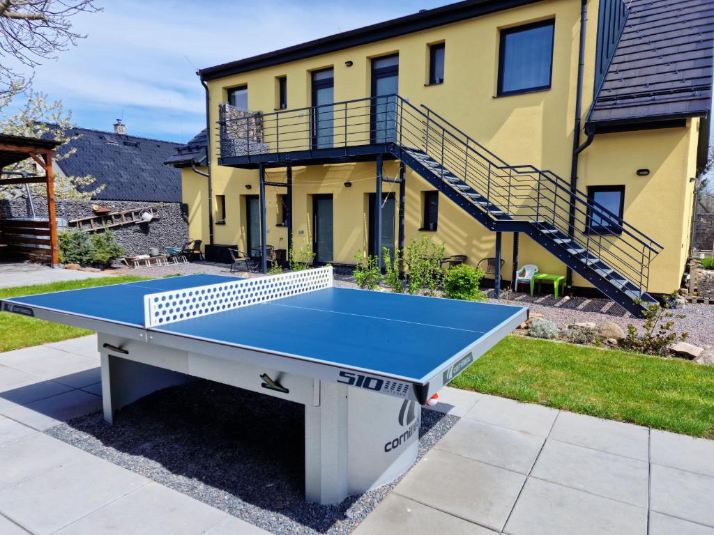 a ping pong table in front of a house at Apartmány Pod Čápy, Nasavrky in Nasavrky