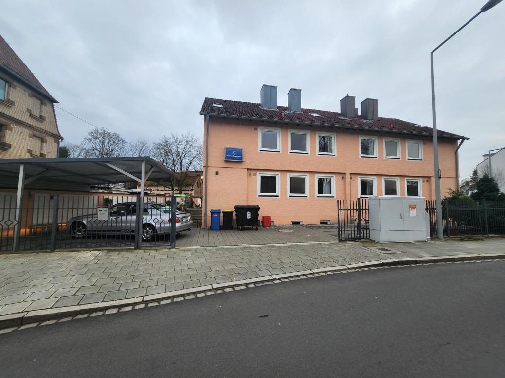 a building with a car parked in front of it at Pension Doppelzimmer mit Balkon 24 