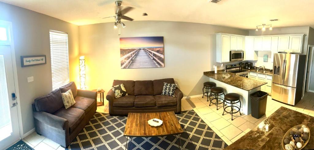 a living room with a couch and a table at Sandy Feet Retreat MS in Gulfport