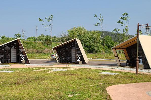 a group of three buildings in a parking lot at Starium Seocheon in Seocheon