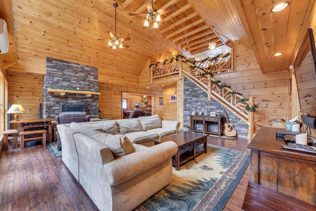 a living room with a couch and a fireplace at Waterfront Old Forge Cabin with Deck and Indoor Pool in Old Forge