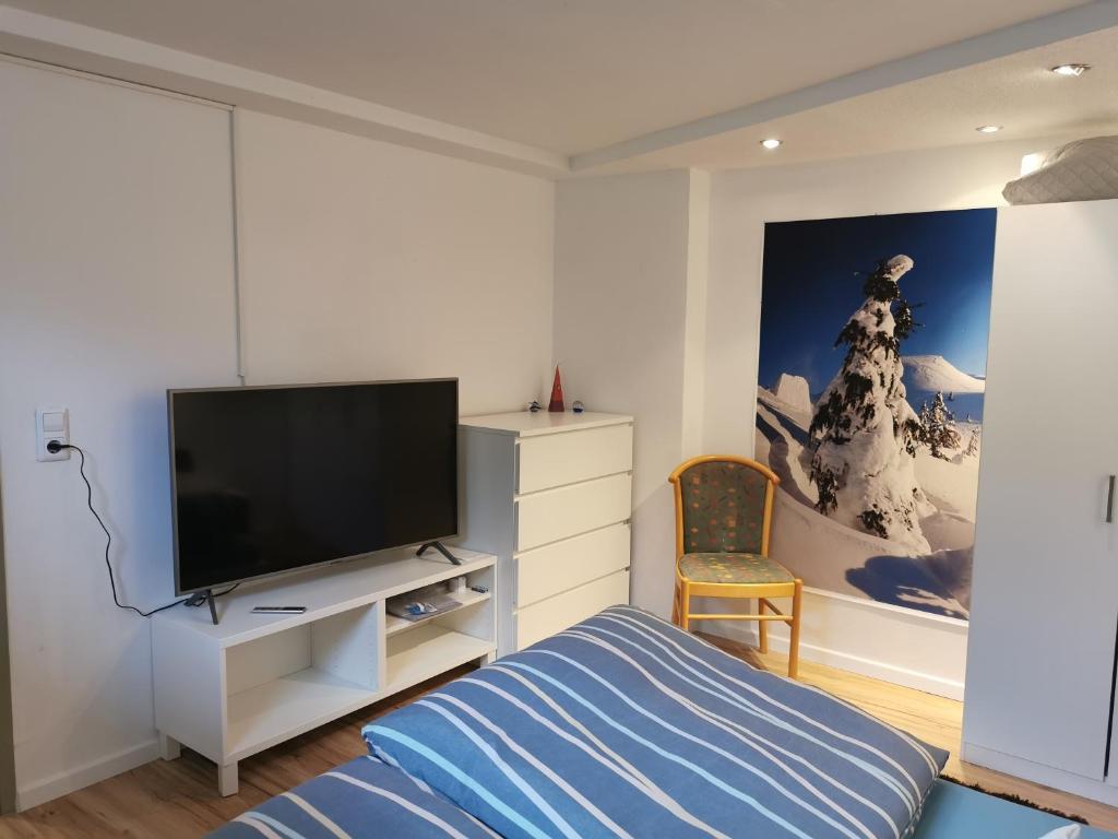 a bedroom with a bed and a flat screen tv at Apart Desiree in Arzl im Pitztal