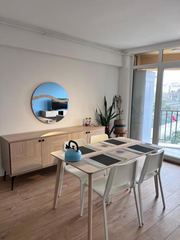 a dining room with a table and a mirror at Allegro Apartments Kadıköy in Istanbul
