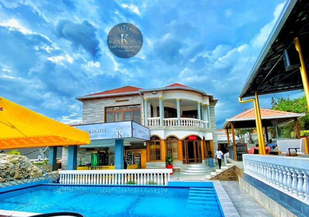 a villa with a swimming pool in front of a house at THE KEZA HOTEL near Kigali international airport. in Kigali