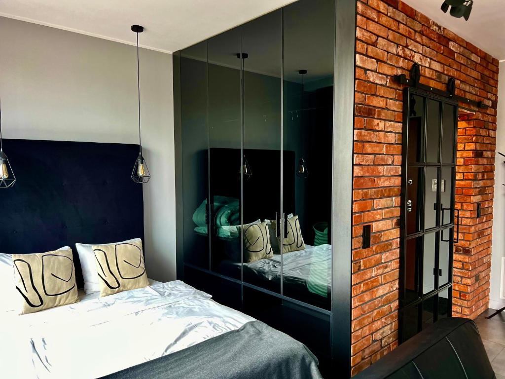 Posteľ alebo postele v izbe v ubytovaní Loft Apartment Browary Warszawskie
