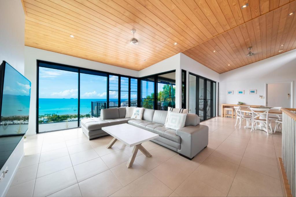 a living room with a couch and a table at Holiday on The Horizon Airlie Beach Holiday Home in Airlie Beach