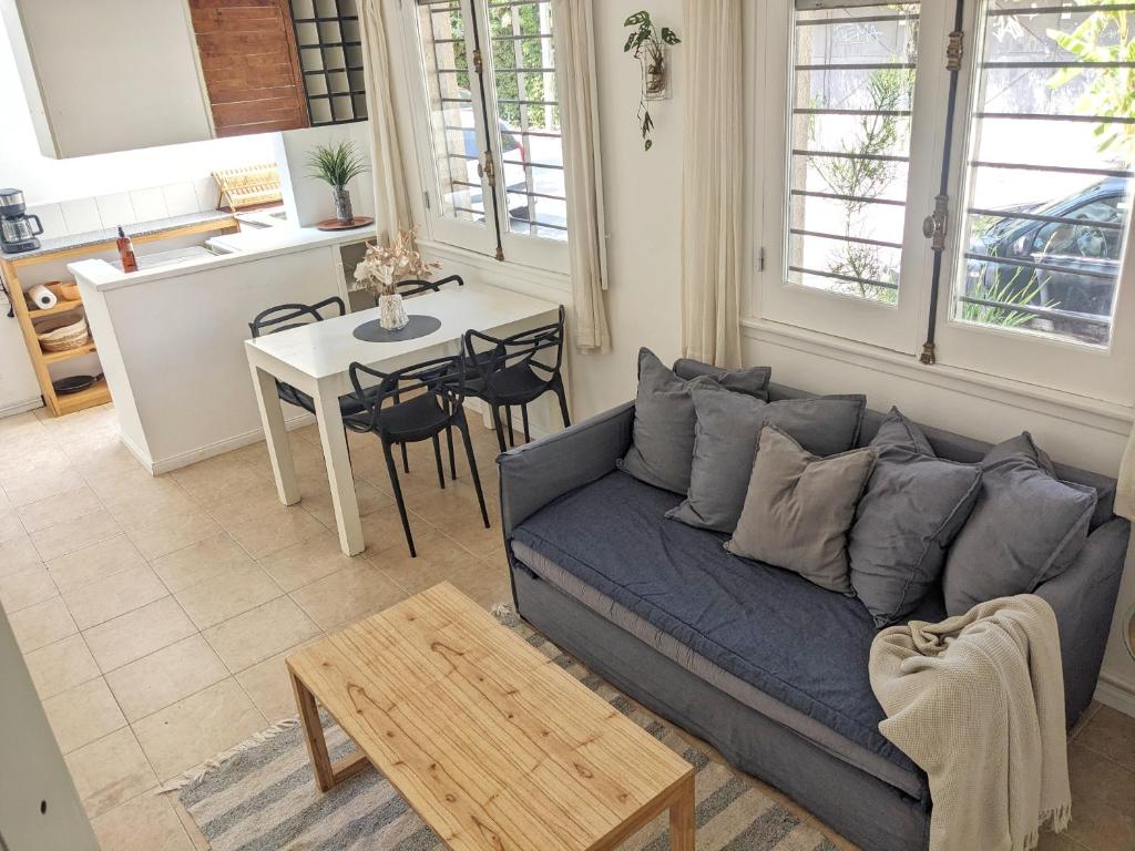 a living room with a blue couch and a table at Hermoso dpto San isidro in San Isidro