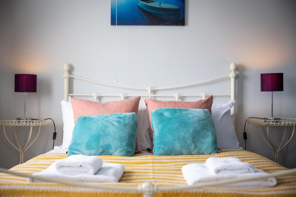 a bedroom with a bed with two towels on it at Entire home in Seacroft, Leeds, UK in Roundhay