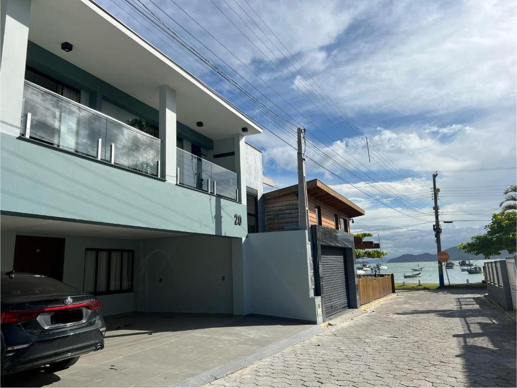 a house with a car parked in front of it at Caminho do Mar Ap 4 in Governador Celso Ramos