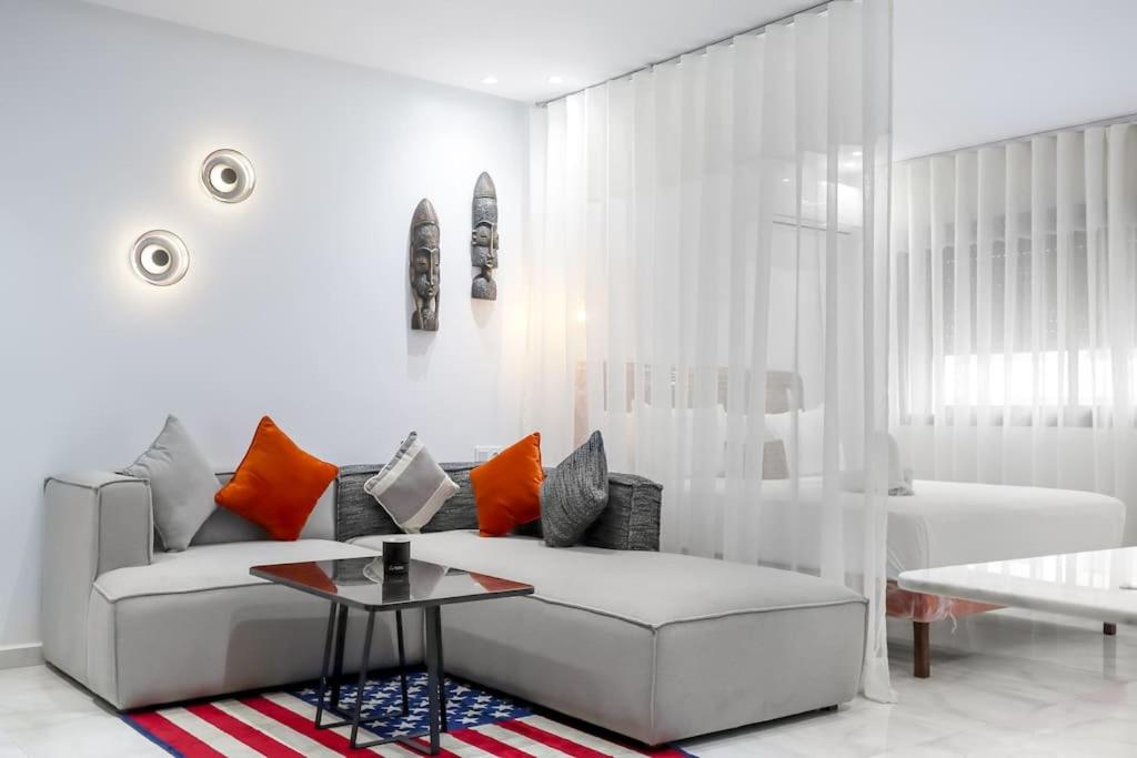 a white living room with a couch and a table at Cozy & Brand New Flat In Casablanca in Casablanca