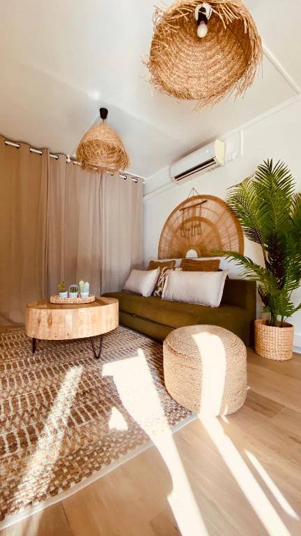 a living room with a couch and a table at T1 luxe à 2 minutes de la plage in Les Trois-Îlets