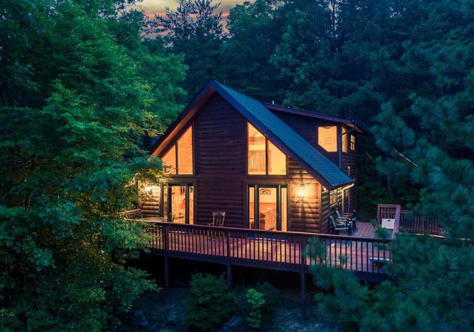 a log cabin in the middle of a forest at NEW HOT TUB! Secluded 3 Bed Cabin in Pigeon Forge in Pigeon Forge