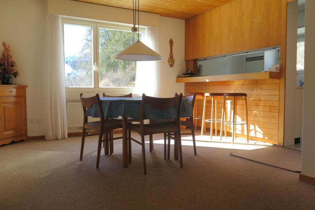 a kitchen with a table and chairs and a window at Apartment Scuol in Scuol