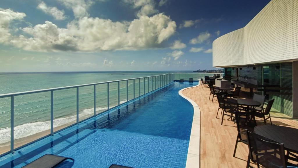 a view of the ocean from the balcony of a resort at RN Studio Premium in Maceió
