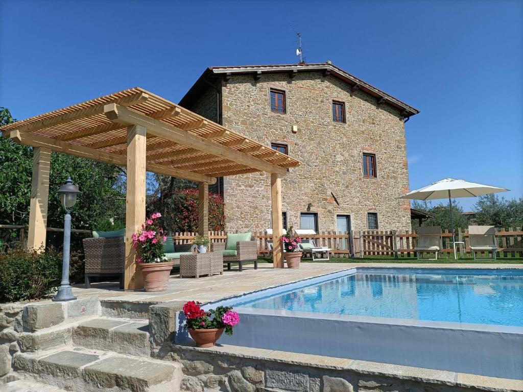una casa con piscina frente a un edificio en Villa Claudia, en Cavriglia