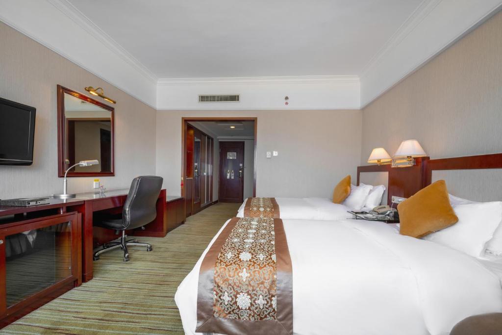 Postel nebo postele na pokoji v ubytování Sunshine Holiday Hotel Fuzhou