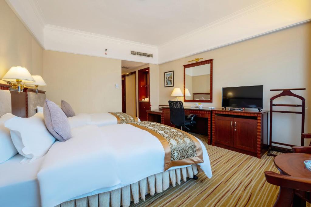 Postel nebo postele na pokoji v ubytování Sunshine Holiday Hotel Fuzhou