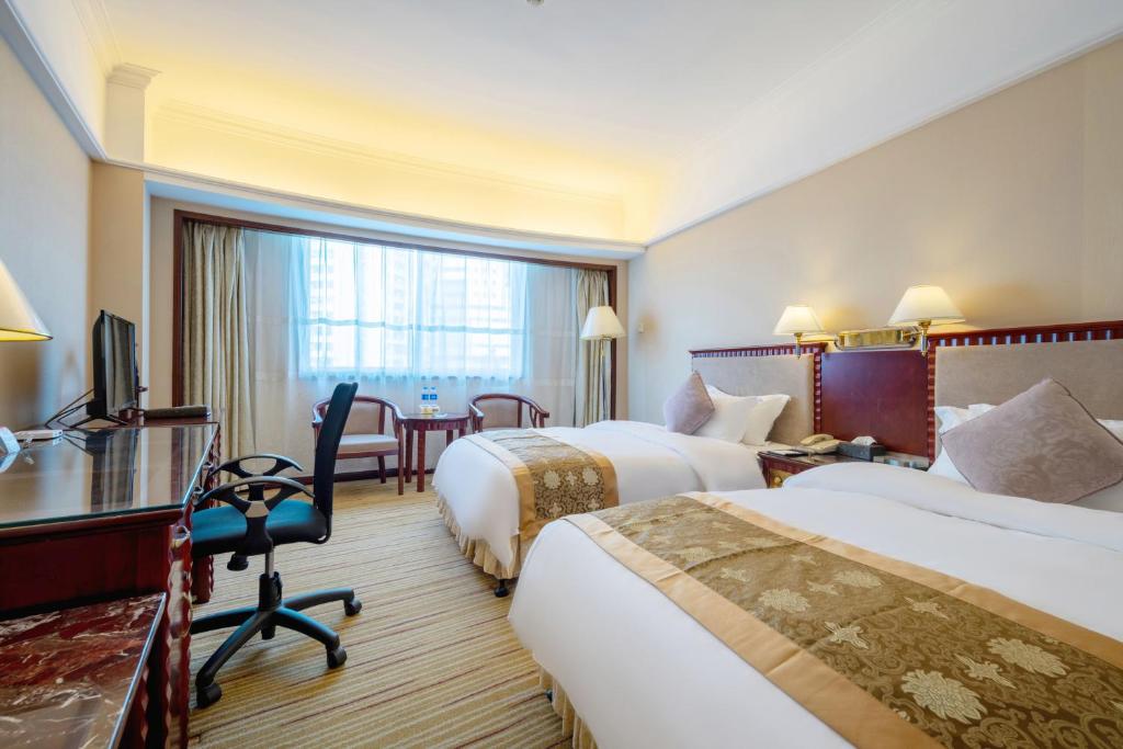 Postel nebo postele na pokoji v ubytování Sunshine Holiday Hotel Fuzhou