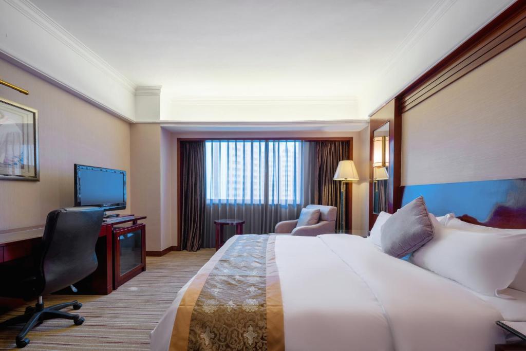 Postel nebo postele na pokoji v ubytování Sunshine Holiday Hotel Fuzhou