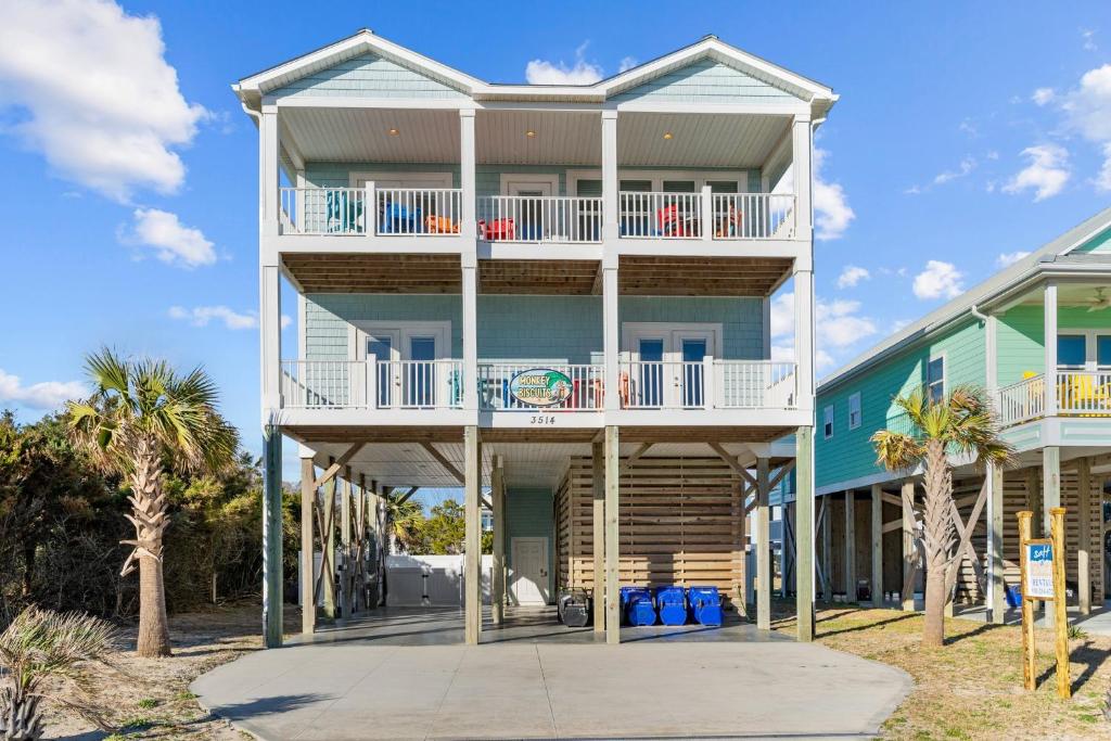 ein großes Haus mit Balkon am Strand in der Unterkunft Luxurious 2nd Row Home w Private Pool, Elevator & Ocean Views in Oak Island