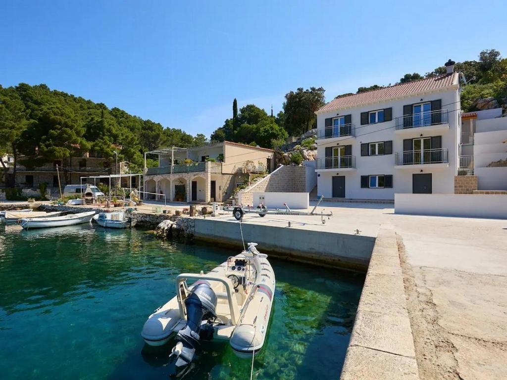 a boat docked in a marina next to a building at Apartments by the sea Okuklje, Mljet - 22341 in Okuklje