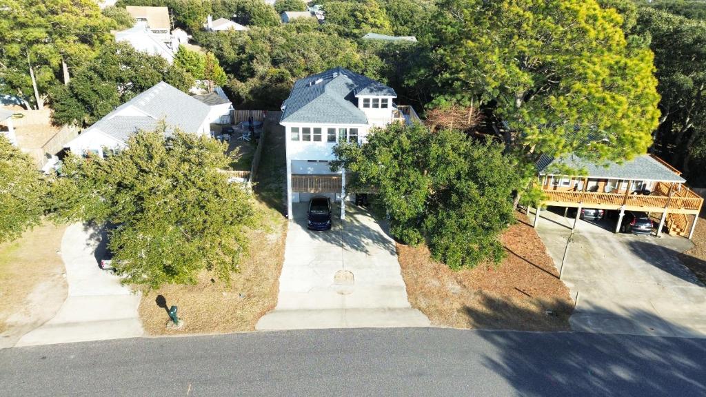 an aerial view of a house with a driveway at Seaside Serenity: Cozy Retreat on Bay Drive in Kill Devil Hills