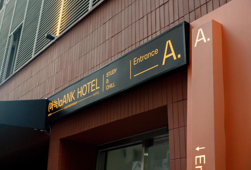 a sign on the side of a building at Aank Hotel Sinchon in Seoul