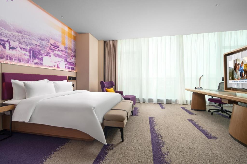 Postel nebo postele na pokoji v ubytování Hampton by Hilton Foshan Shunde Beijiao