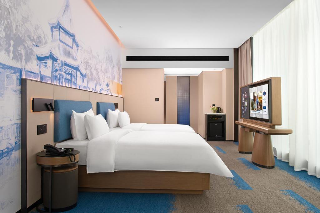 Postel nebo postele na pokoji v ubytování Hampton by Hilton Foshan Shunde Beijiao