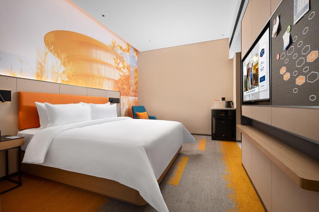 Postel nebo postele na pokoji v ubytování Hampton by Hilton Foshan Shunde Beijiao