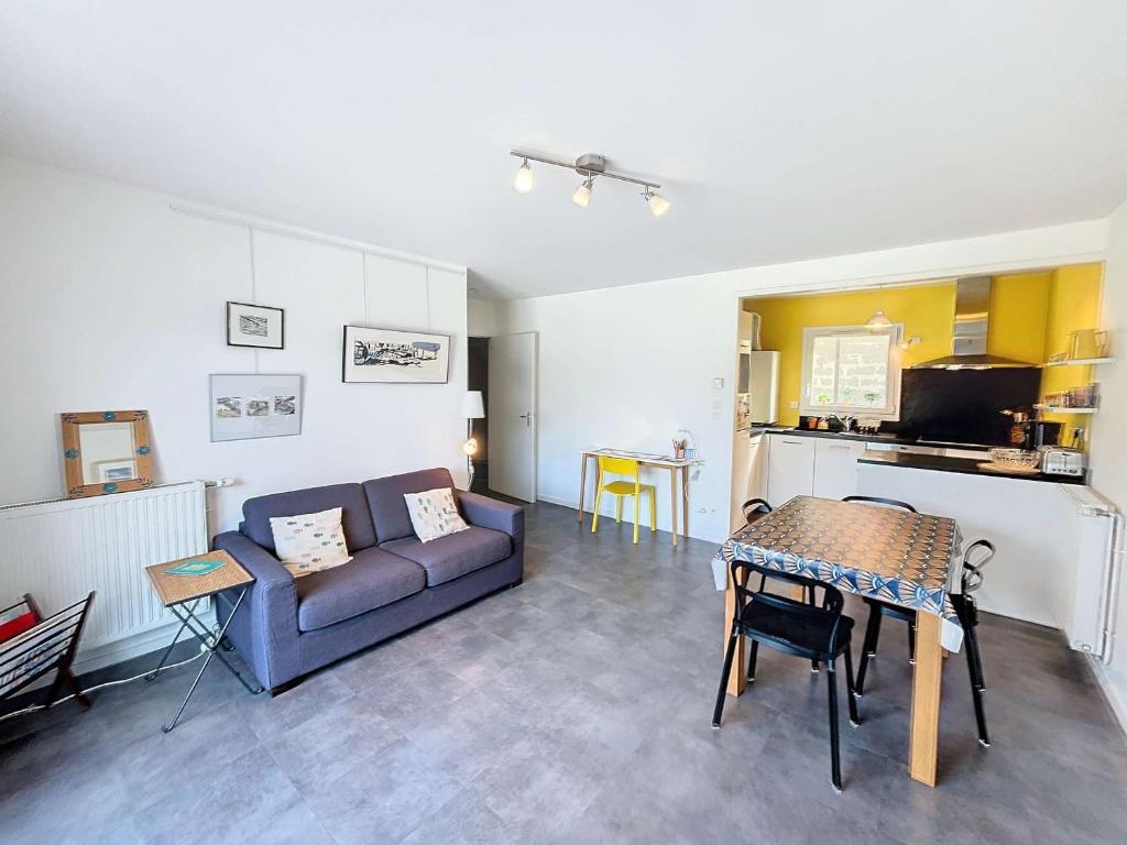 un salon avec un canapé et une table dans l'établissement Appartement moderne centre-ville, 600m plage, résidence sécurisée, parking - FR-1-361-368, à Granville