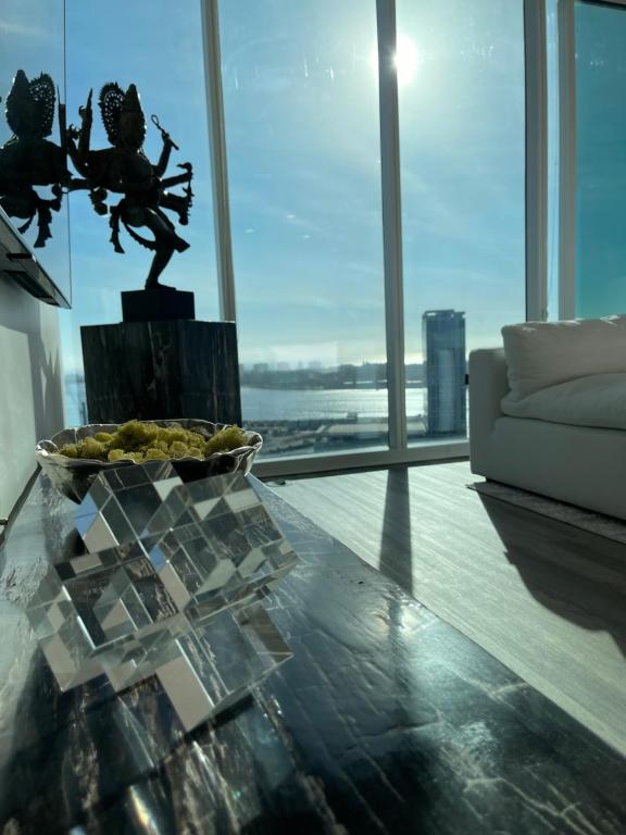 a living room with a glass table and a couch at Massive Penthouse Overlooking All of San Diego in San Diego