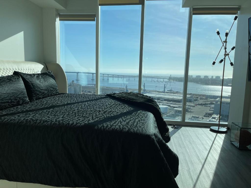 a bedroom with a bed and a view of the ocean at Massive Penthouse Overlooking All of San Diego in San Diego