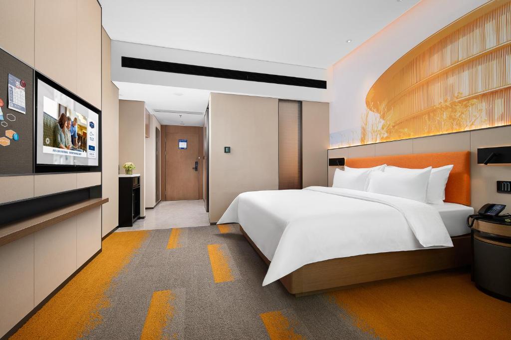 Postel nebo postele na pokoji v ubytování Hampton by Hilton Foshan Shunde Beijiao