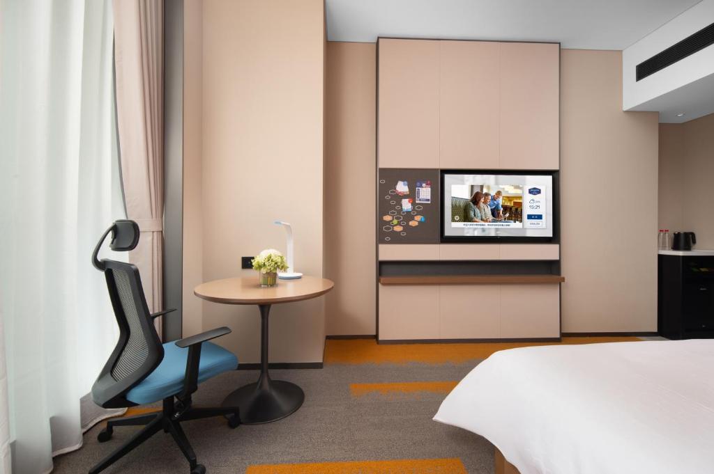 Postel nebo postele na pokoji v ubytování Hampton by Hilton Foshan Shunde Beijiao