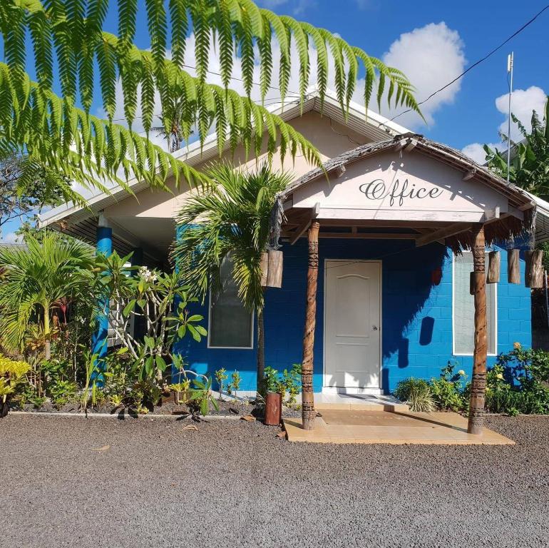a blue house with a sign that reads office at LE RIC HOUSING LTD in Apia