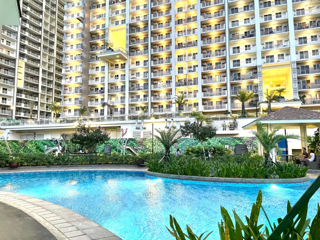 a large apartment building with a large swimming pool at mushROOM Condotel at Prisma Residences, Pasig City in Manila