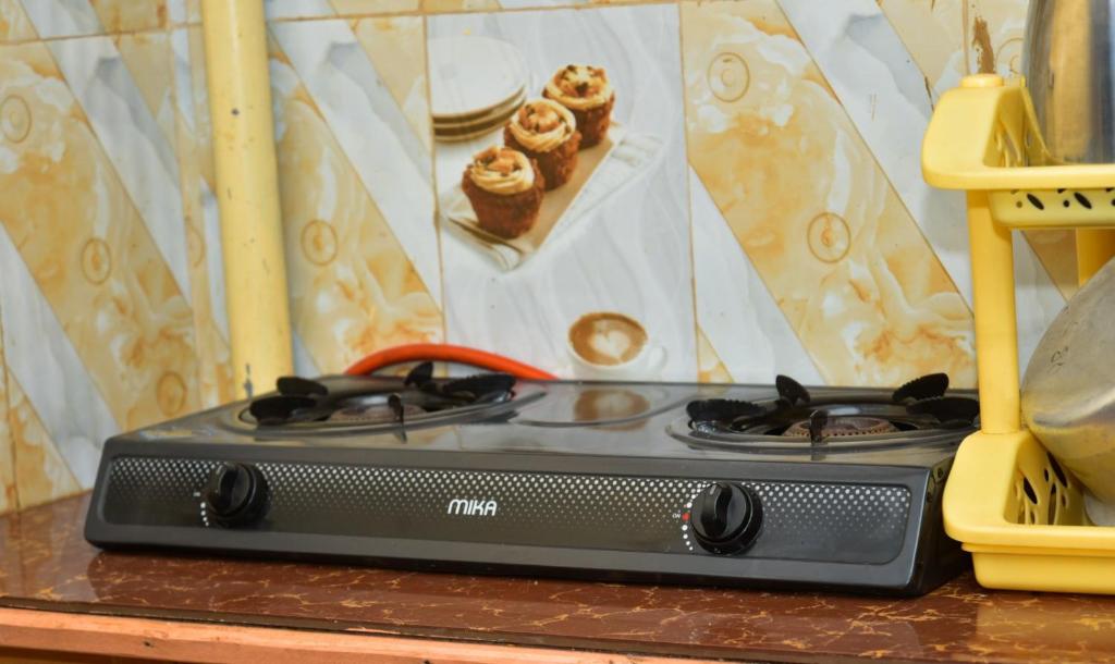 a toy stove sitting on top of a table at Qwetu Homes in Keruguya