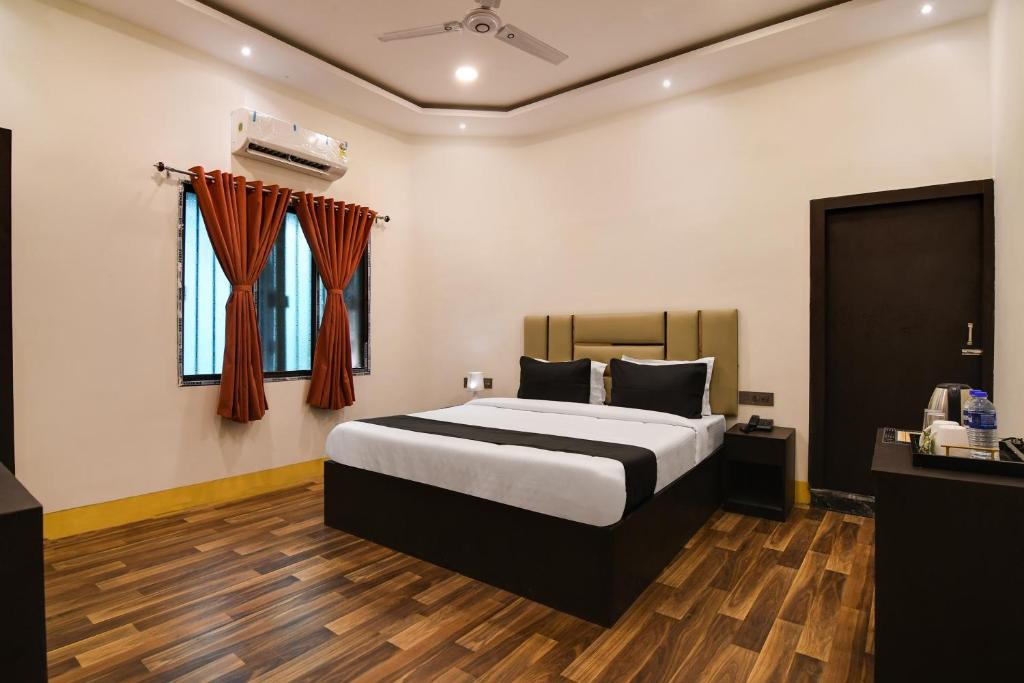 a hotel room with a bed and a window at OYO Hotel sakina in Kolkata