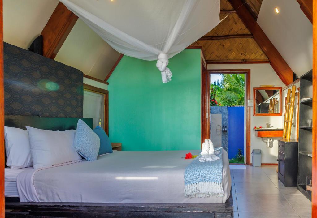 Postel nebo postele na pokoji v ubytování Mango Bay Resort