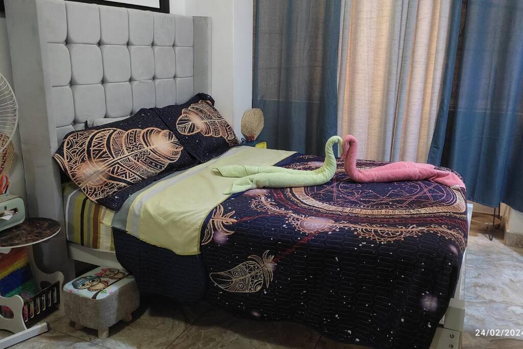 - une chambre avec un lit et une couette dans l'établissement mini departamento tipo loft .en puente piedra., à Puente Piedra