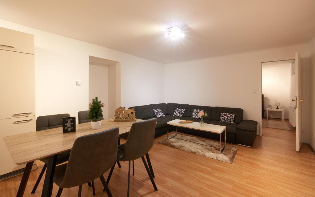 ein Wohnzimmer mit einem Tisch und einem Sofa in der Unterkunft Spacious Apartment near Schoenbrunn Castle in Wien