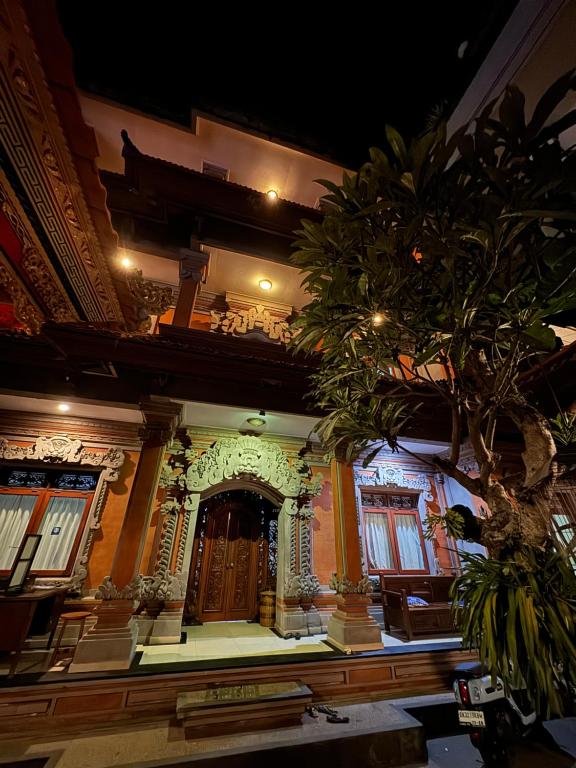 a large building with a large door in a room at Nua House in Ubud