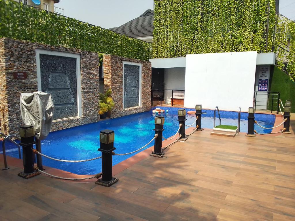 a pool with blue water in front of a building at St Theresas apartment Lodge 3 in Lekki