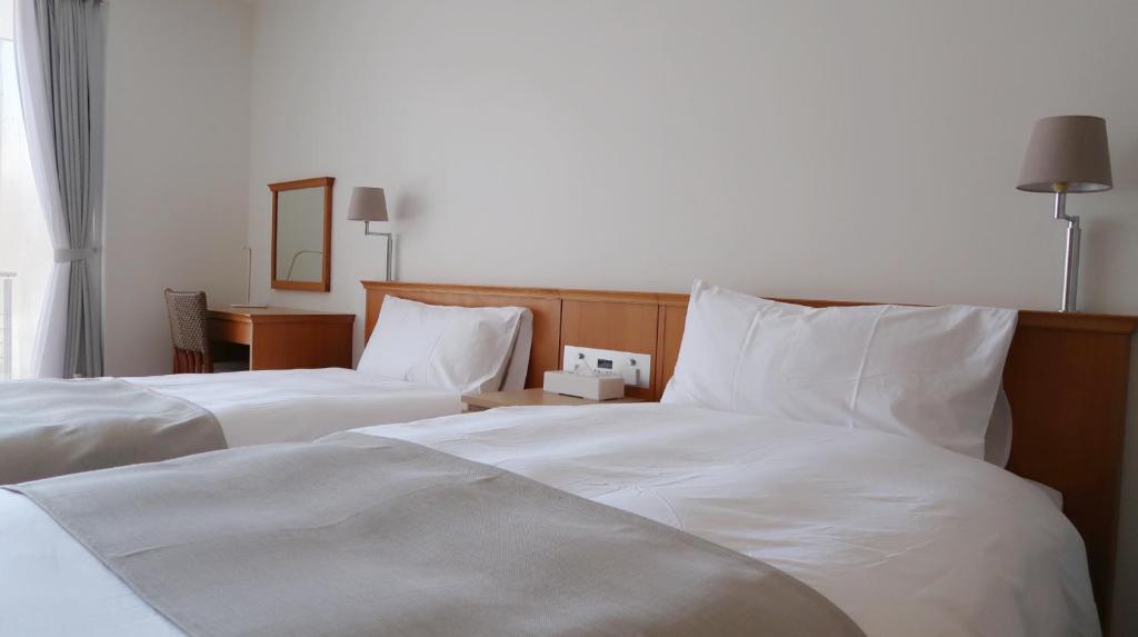 Postel nebo postele na pokoji v ubytování Karuizawa Tennku Hotel & Resort