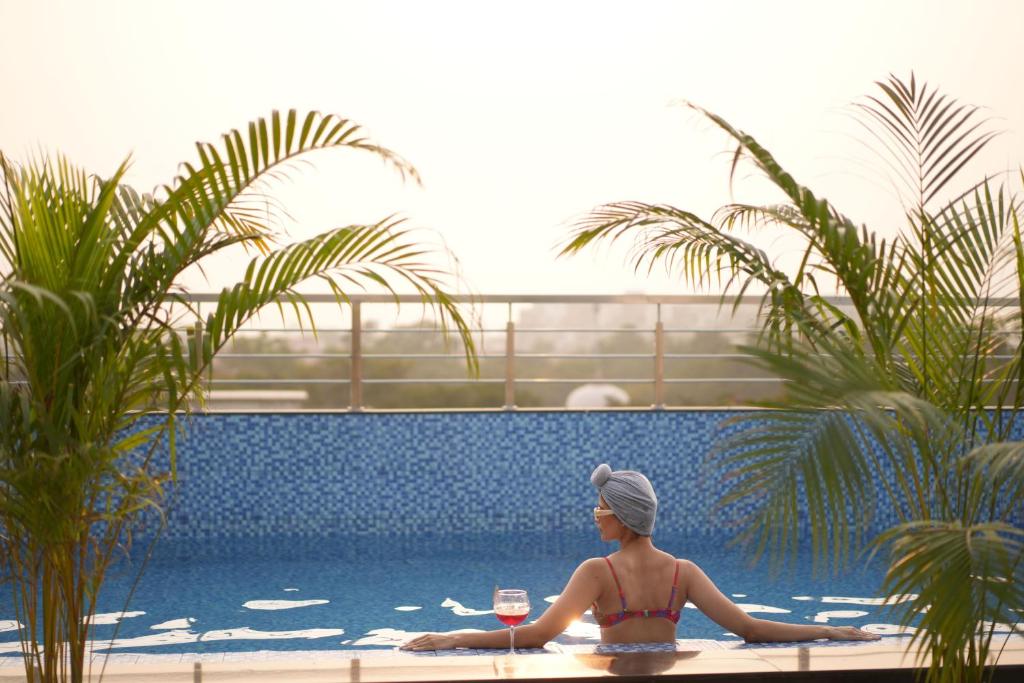 a woman in a bikini sitting in a swimming pool at The LIV Hotel Jaipur in Jaipur