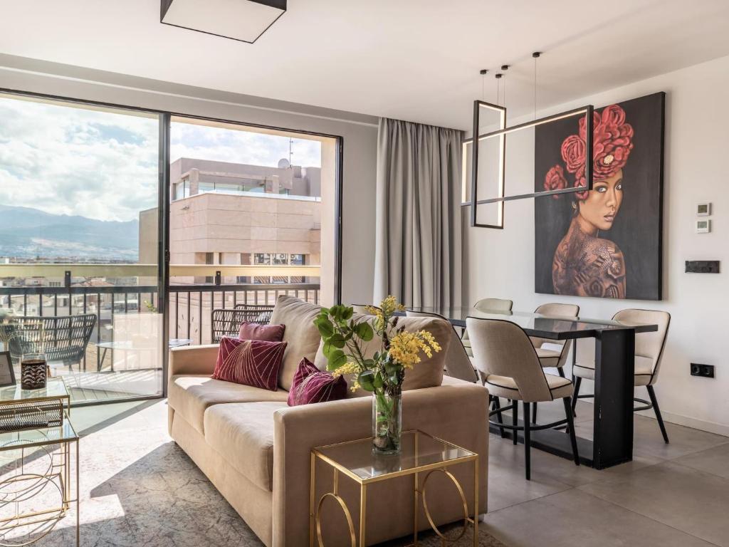 a living room with a couch and a table at Luxury Alhambra Penthouse Collection in Granada