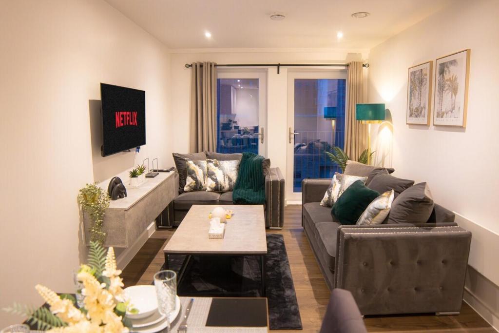 ein Wohnzimmer mit einem Sofa und einem Tisch in der Unterkunft Luxury Stay 5 mins to Manchester city centre! in Manchester