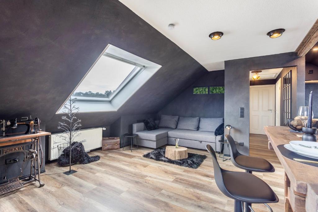 a living room with a couch and a window at Industrial in Schloß Holte-Stukenbrock